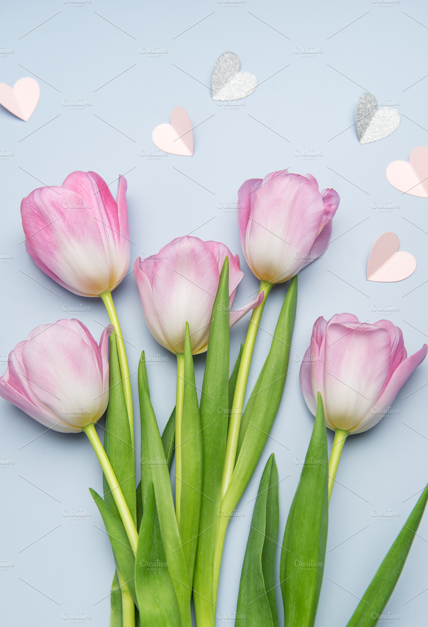 Pink tulips and paper hearts creating a romantic atmosphere, a Holiday Photo by Olena Rudo