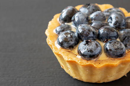 Blueberry tart on black background, side view. Copy space., a Food & Drink Photo by LiudmylaChuhunova