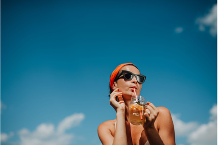 Young woman sitting by swimming pool