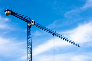 Blue tower crane with cab and counterweights set against a brigh, a Nature Photo by Ales Munt