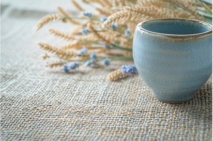 Handmade ceramic cup on textured, a Background Photo by Lermont51