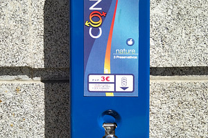 Condom dispenser on house wall, a Health & Medical Photo by DanFLCreativo
