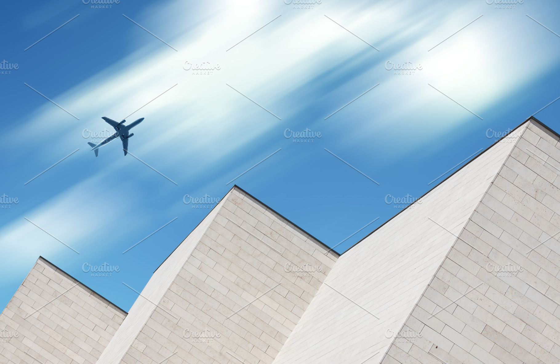 Airplane flying over modern building, a Transportation Photo by BOOCYS