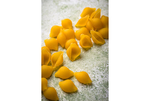 Raw pasta in shape of shells, a Food & Drink Photo by Yulia Furman