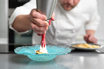 Professional chef holding a foam siphon in a restaurant kitchen., a Person Photo by david.herraez.calzad