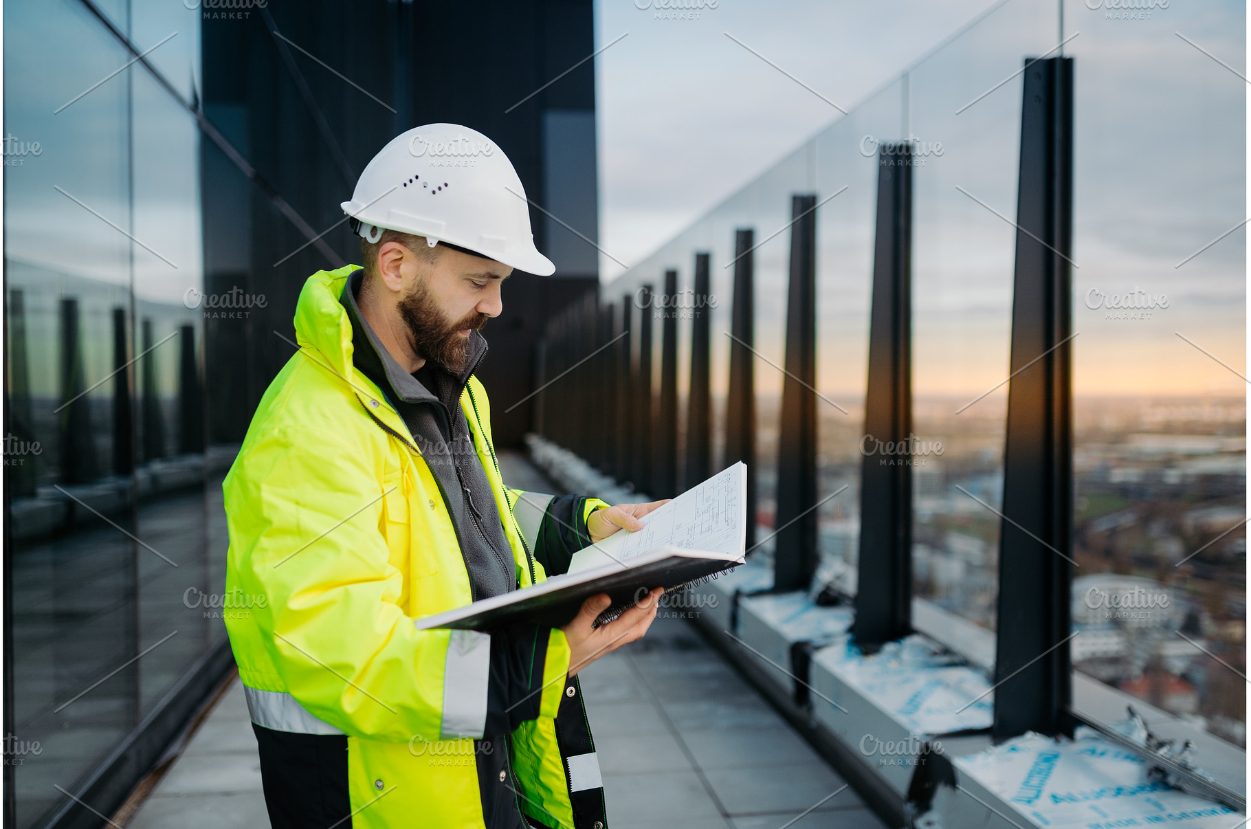 Engineer overseeing city, an Industrial Photo by HalfPoint