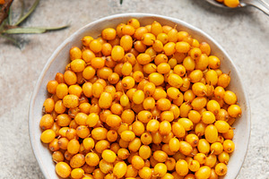 Sea buckthorn berries in bowl healthy eating concept, a Food & Drink Photo by Olena Rudo