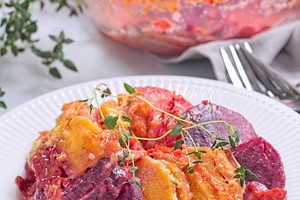 Sweet potato, parsnips and beet root au gratin with thyme and melted cheese, on, a Food & Drink Photo by iuliia_n
