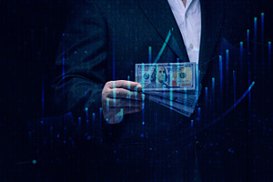 A man in a suit holds a wad of hundred-dollar bills against a ba, a Business Photo by ndanko
