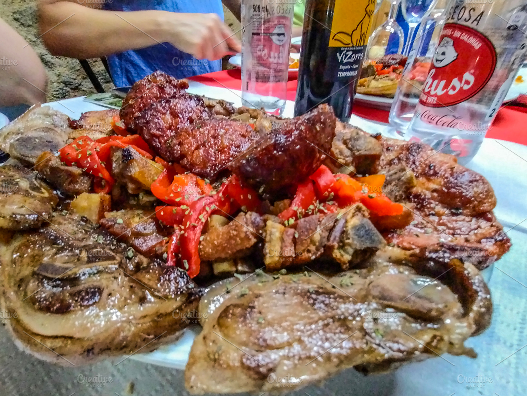 Mixed grilled meats on rustic dining table, a Food & Drink Photo by DanFLCreativo