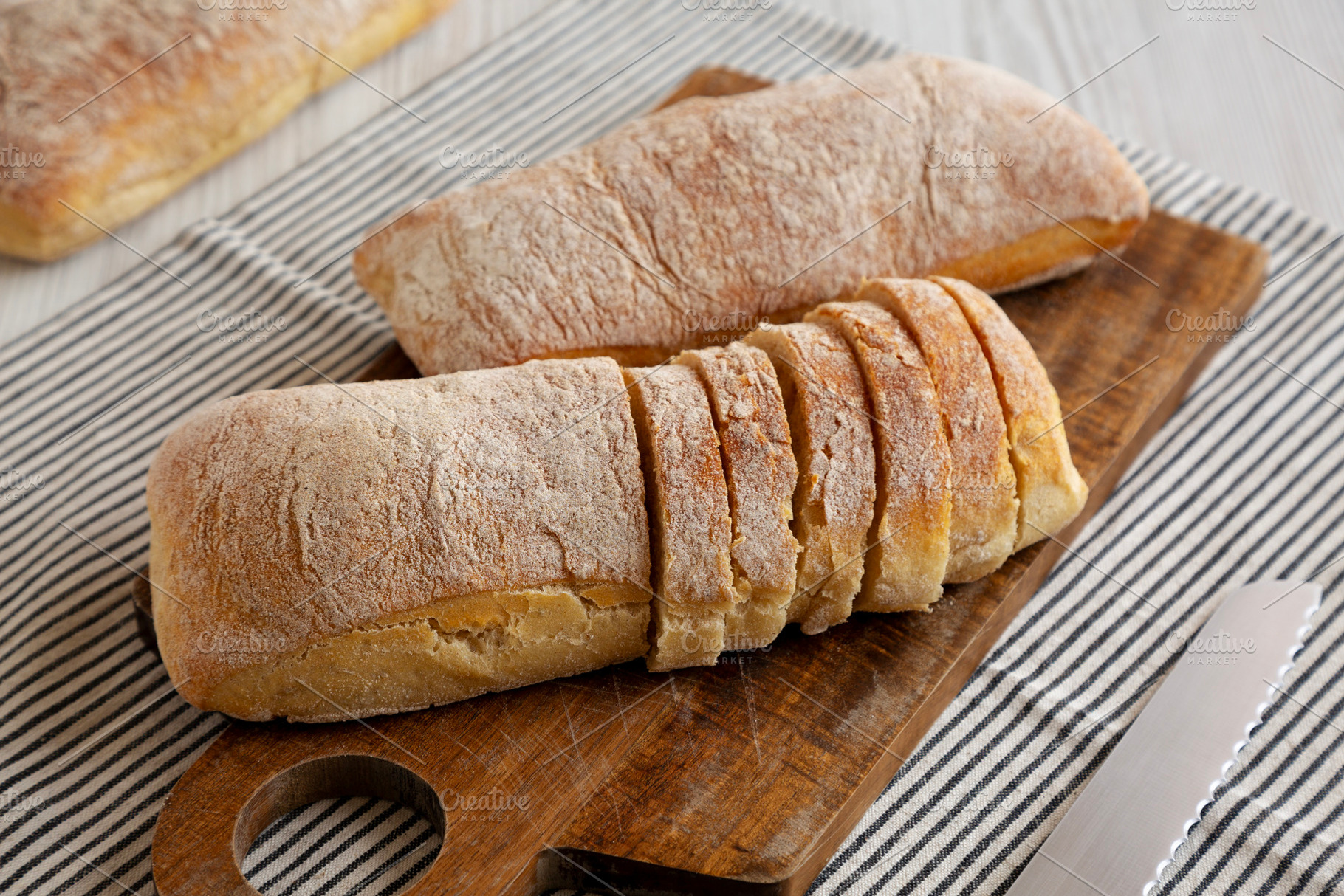 Homemade Ciabatta Bread on a wooden board, side view., a Food & Drink Photo by LiudmylaChuhunova