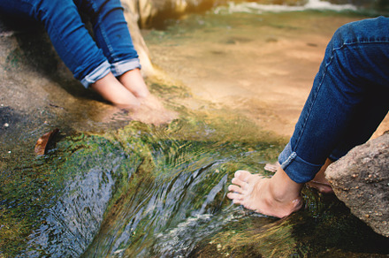 Feet of children in water, a Person Photo by sawitree