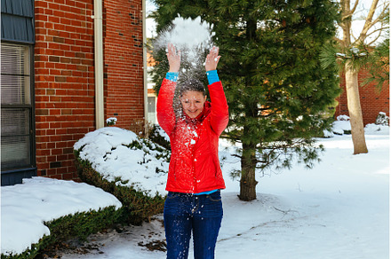 Cute young woman playing with snow, a Person Photo by Ungvar Studio