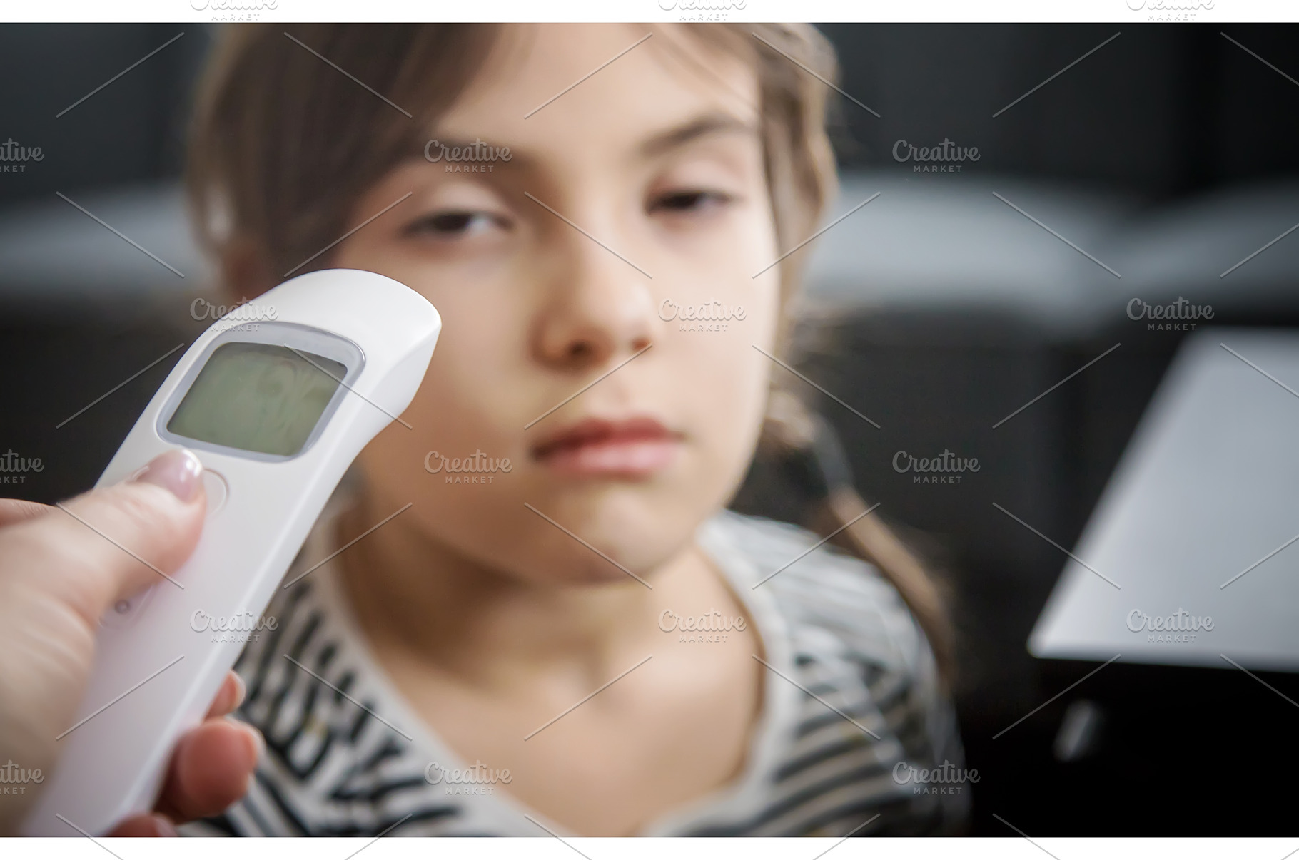 The mother measures the temperature, a Person Photo by yanadjana