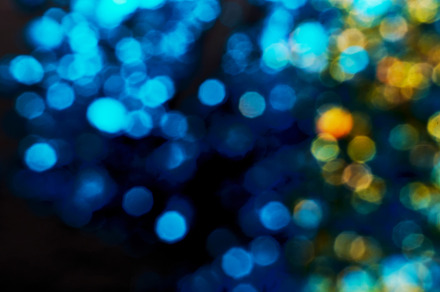 Black festive background. Abstract blue and gold bokeh lights on black. Holiday, an Abstract Photo by colnihko