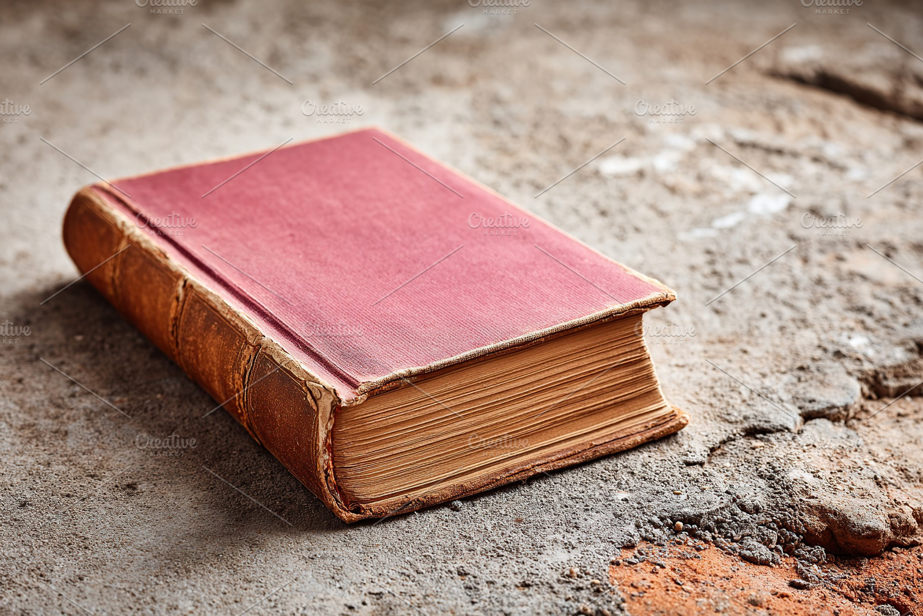 Weathered book resting on a rough surface in an abandoned space on a quiet afte, a Photo by AlyaAnd