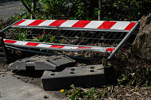 Fallen metal barrier surrounded by foliage in Mosfellsbær Iceland's natural se, a Photo by AS photostudio