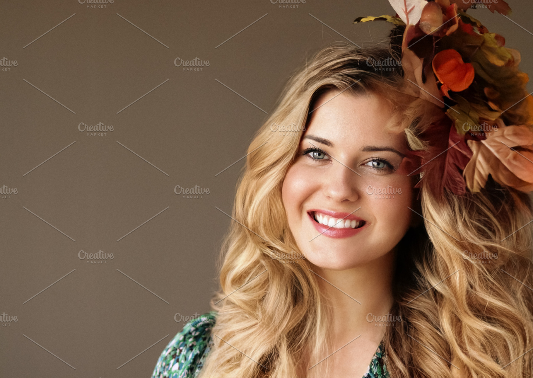 Beautiful woman smiling, wearing autumn leaves in her long wavy, a Person Photo by Studio ANNA