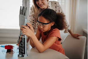 Mom teaching daughter robotics and, a Technology Photo by HalfPoint