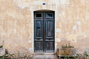 Old wooden closed door featuring 12, re, and village