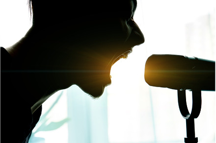 Silhouette of a man singing into a, a Person Photo by darksoul72