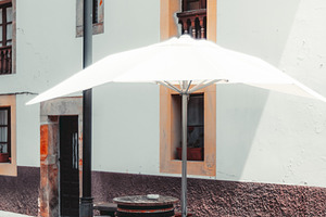 Barrel table with stools, umbrella, an Industrial Photo by SkyNext