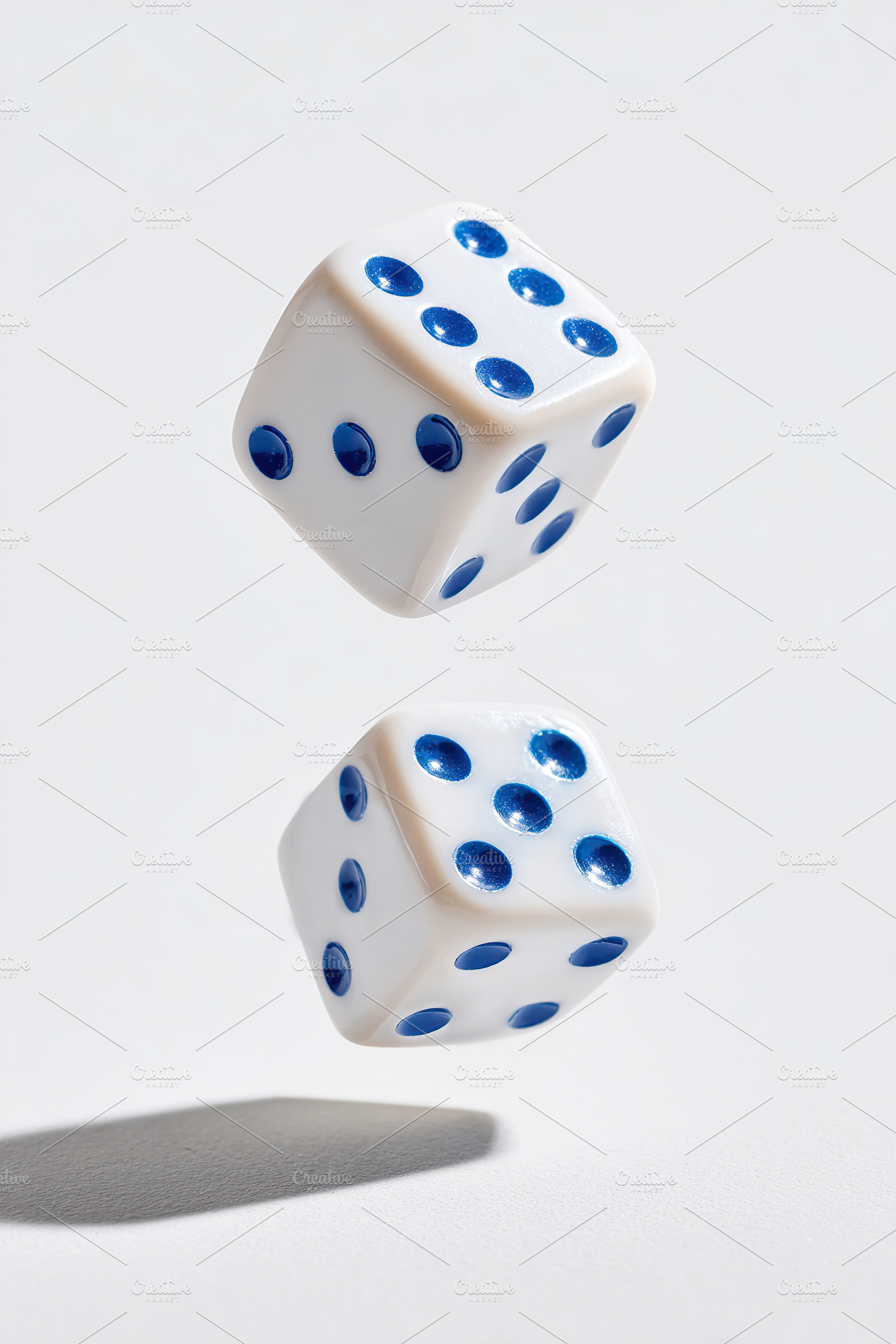 Floating white dice with blue dots captured in motion during a gaming session, a Sports & Recreation Photo by AlyaAnd