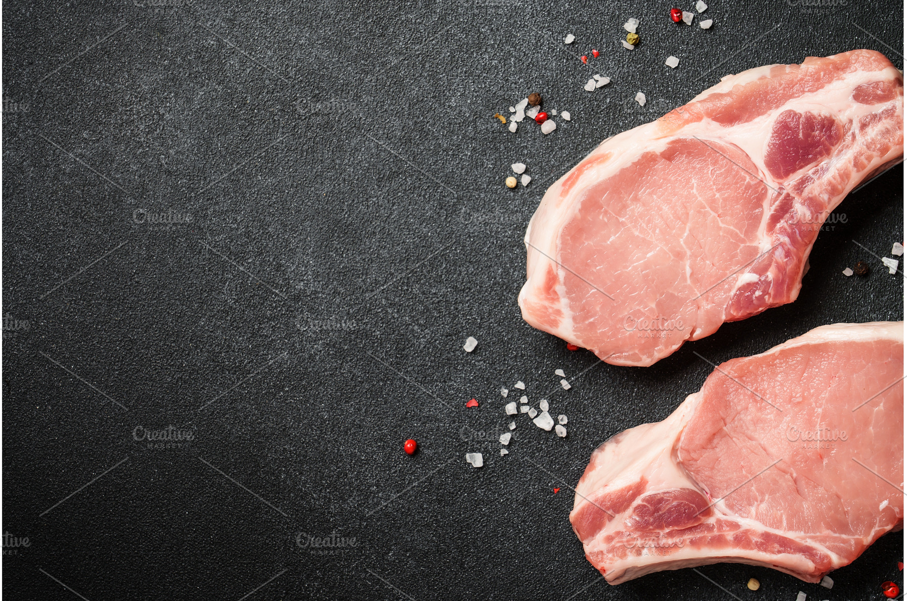 Raw pork meat steaks on black, a Food & Drink Photo by Nadia-nb