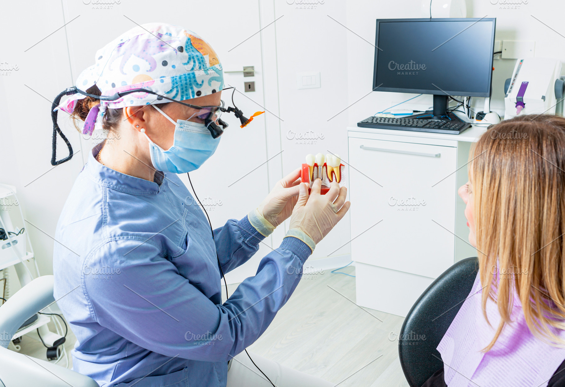 Dentist explaining dental implant procedure to patient with anat, a Health & Medical Photo by Antonio Gravante Market