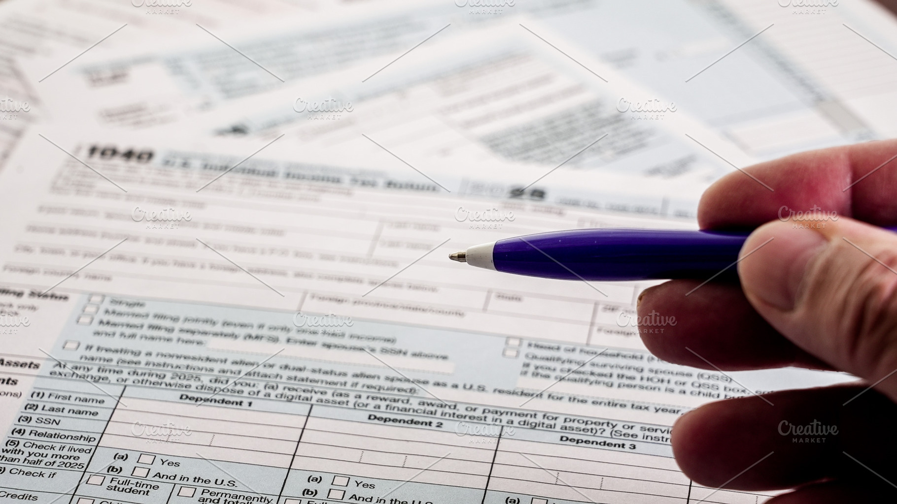 Completing 1040 tax forms with a pen, a Business Photo by 1miromiro