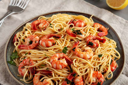 Homemade Cooked Garlic Shrimp Scampi on a Plate, side view., a Food & Drink Photo by LiudmylaChuhunova