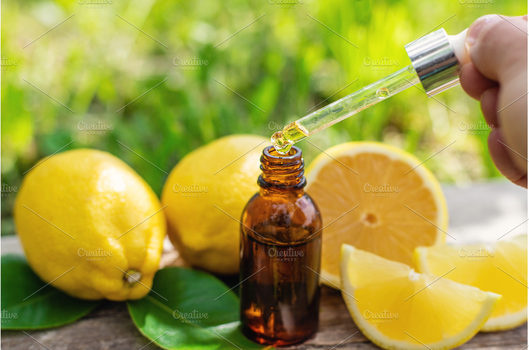 lemon essential oil in a bottle, a Beauty & Fashion Photo by yanadjana
