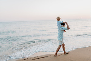 Rear view of father carrying a, a Person Photo by HalfPoint