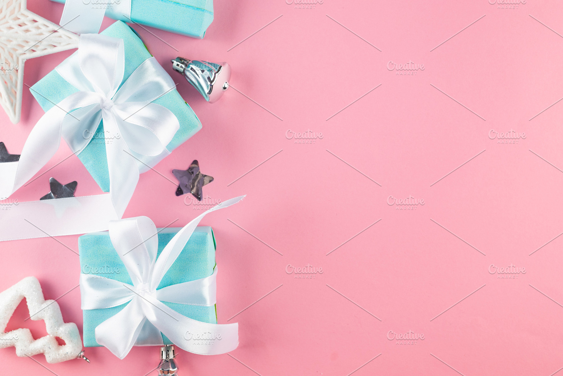 Holidays gift box wrapped in blue paper, balls, glitter on pink, a Holiday Photo by vimart