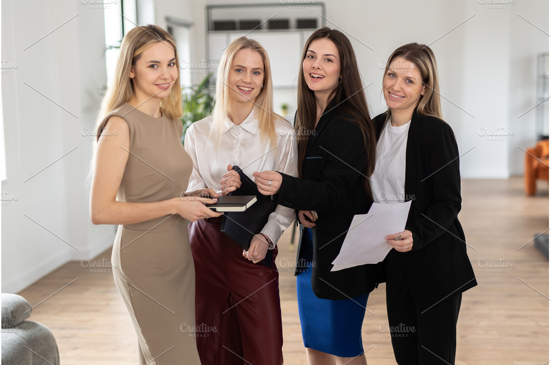 Four confident businesswomen stand, a Person Photo by undrey