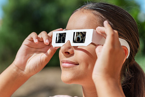 Young girl watches a solar eclipse, a Person Photo by Volff