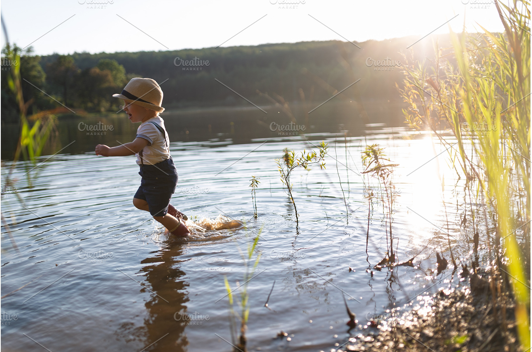 Toddler running through lake, a Person Photo by HalfPoint
