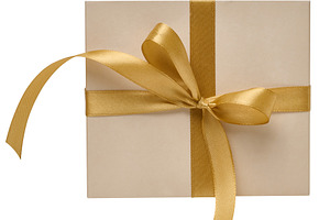 Beige gift box with golden satin ribbon on isolated background, a Holiday Photo by ndanko