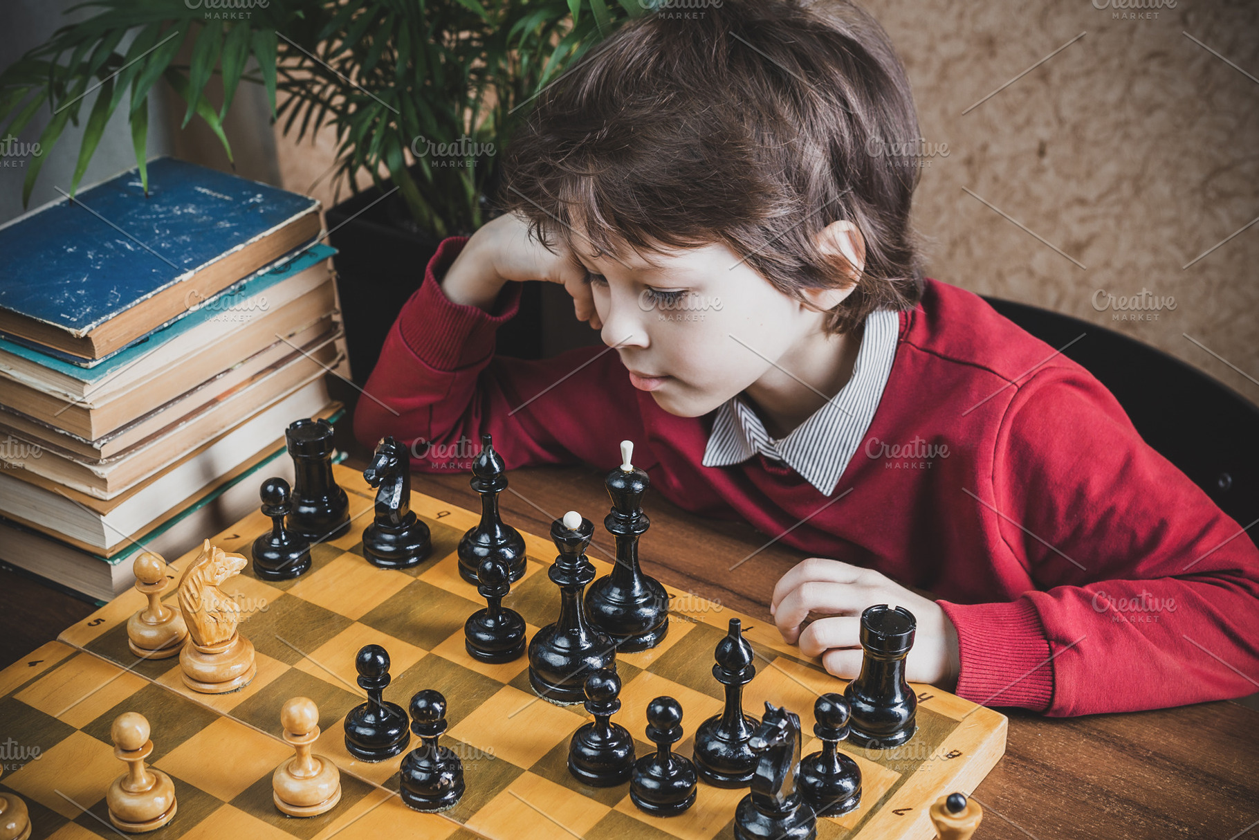 Boy playing chess with himself, a Person Photo by Andriana Syvanych