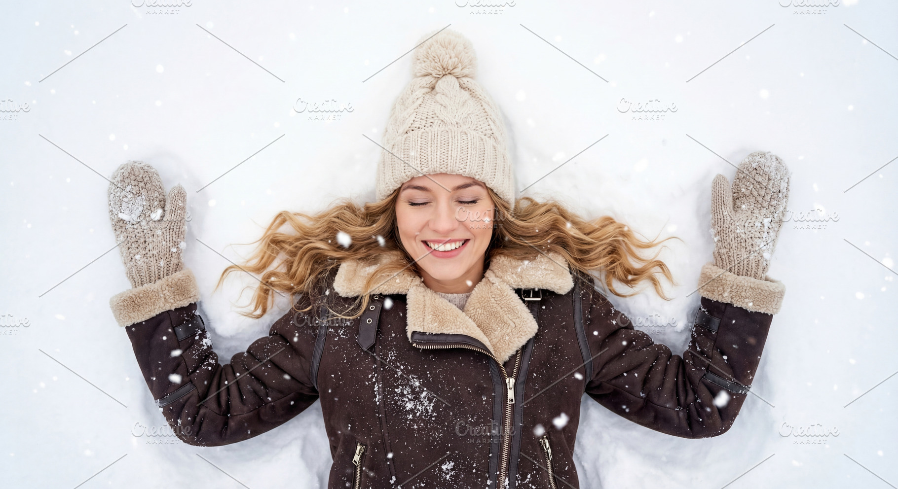 Happy Young Woman Making Snow Angel, a Person Photo by Virgo Studio