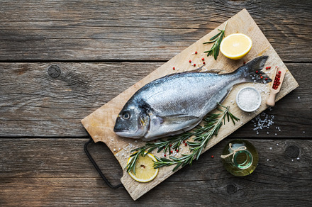 Fresh dorado fish with lemon slices., a Food & Drink Photo by chamillewhite