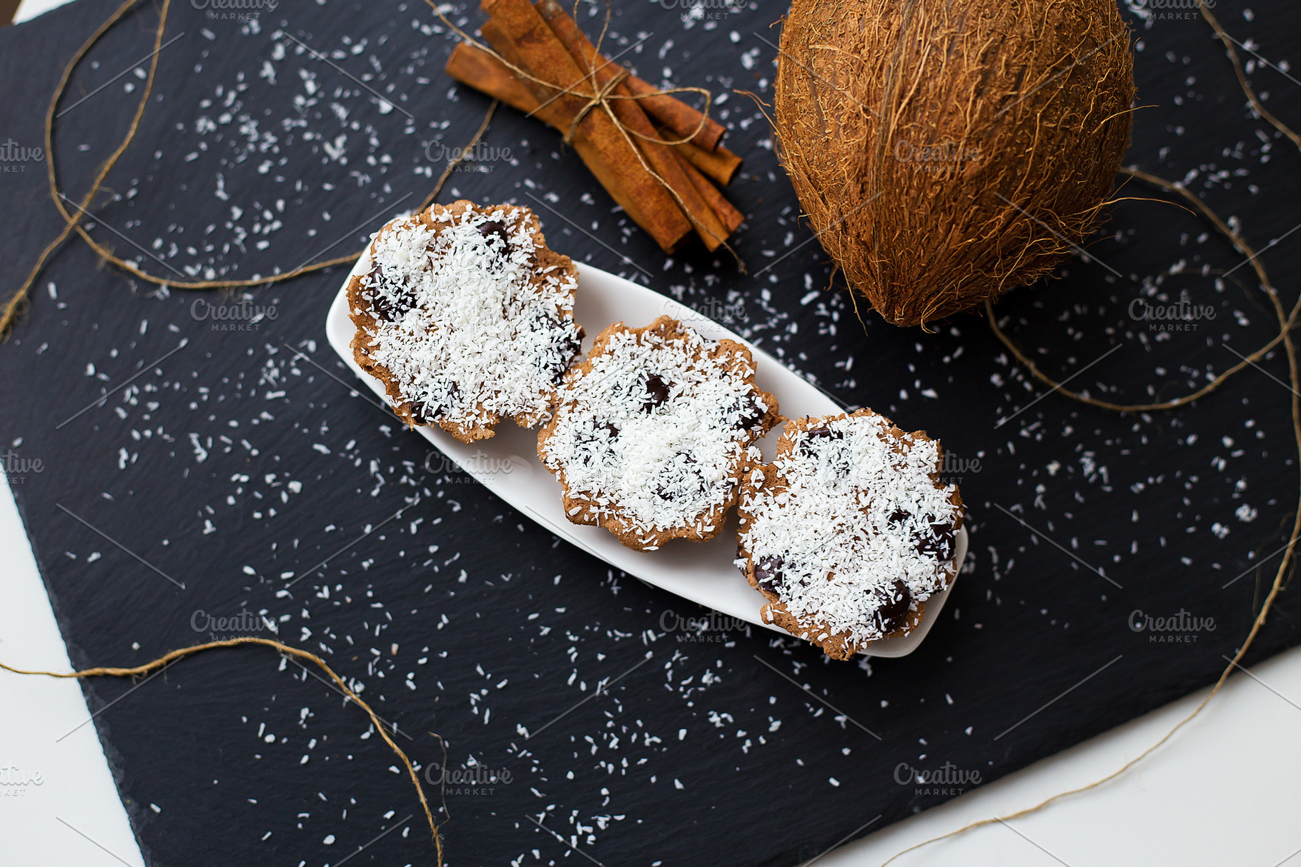 coconut muffins on a black background, a Food & Drink Photo by Artsaba Family
