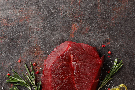 Concept of tasty food with raw beef steak on dark textured backg, a Food & Drink Photo by AtlasStudio PRO