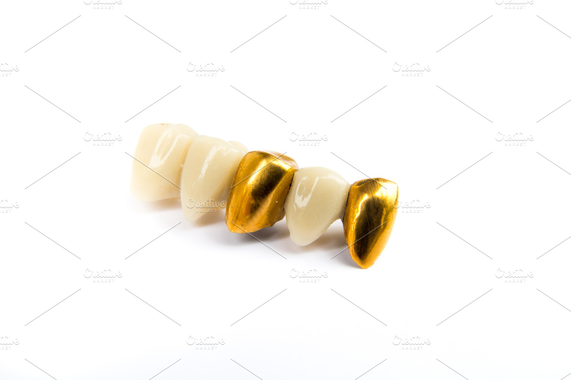 Dental ceramic and gold tooth crowns on white background isolated containing, a Health & Medical Photo by Life For Photo