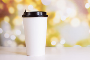 White paper cup of coffee to go containing addiction, background, and blurred