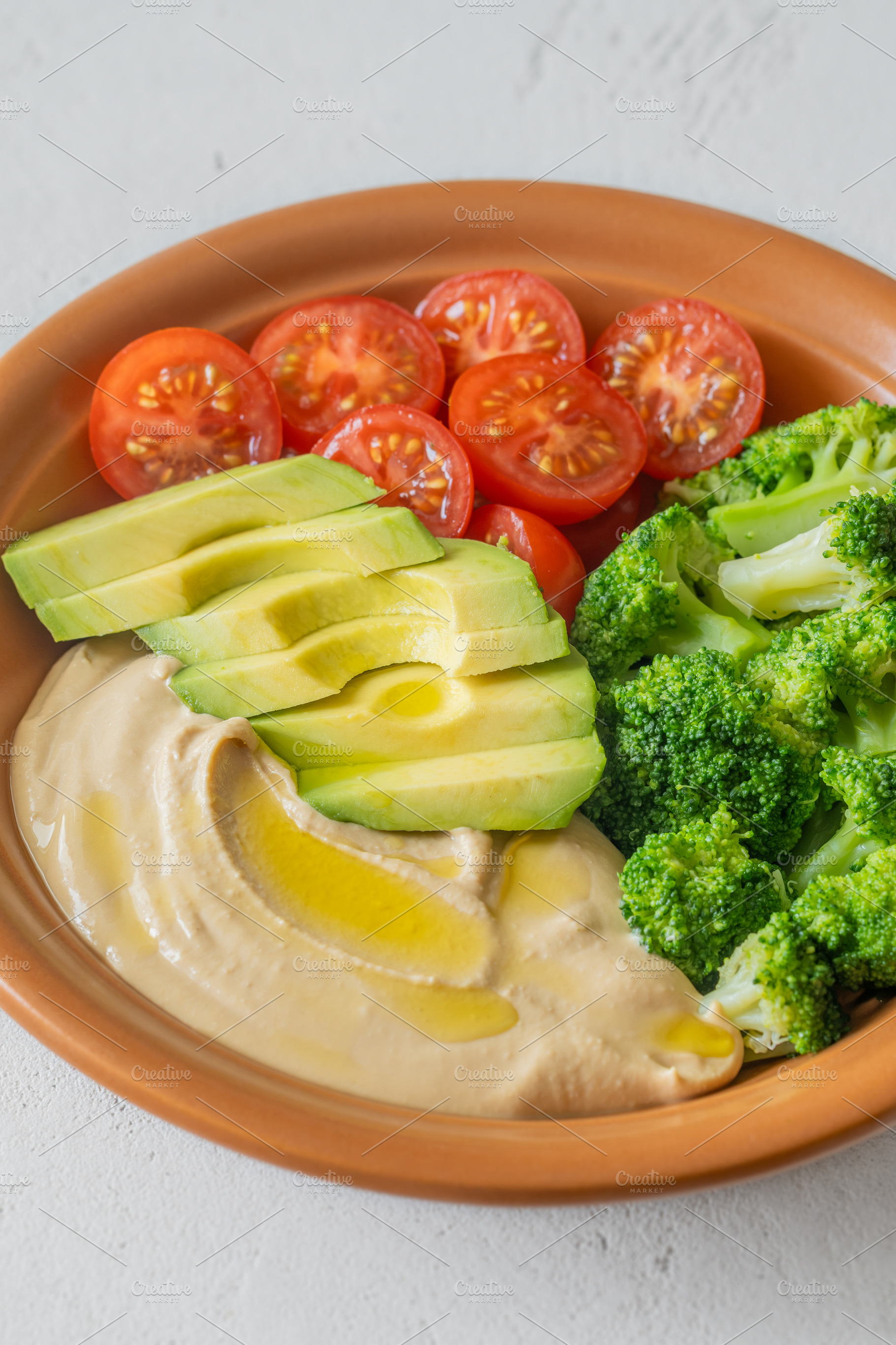 Healthy Hummus Bowl With Avocado Broccoli And Cherry Tomatoes, a Food & Drink Photo by Alexander Prokopenko