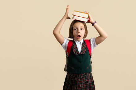 Girl in school uniform with two text, a School & Education Photo by Elena Vagengeim