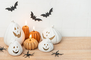Decorating for halloween with ceramic pumpkins and lit candles