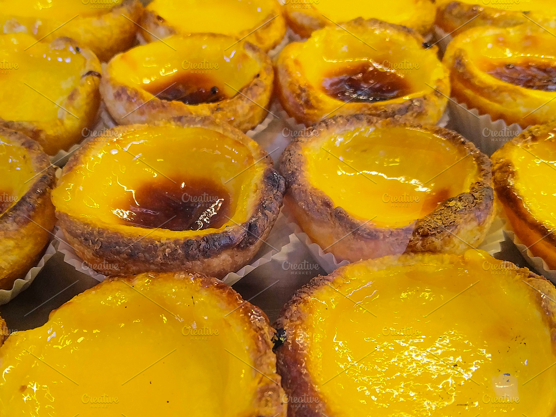 Portuguese custard tarts in bakery display, a Food & Drink Photo by DanFLCreativo