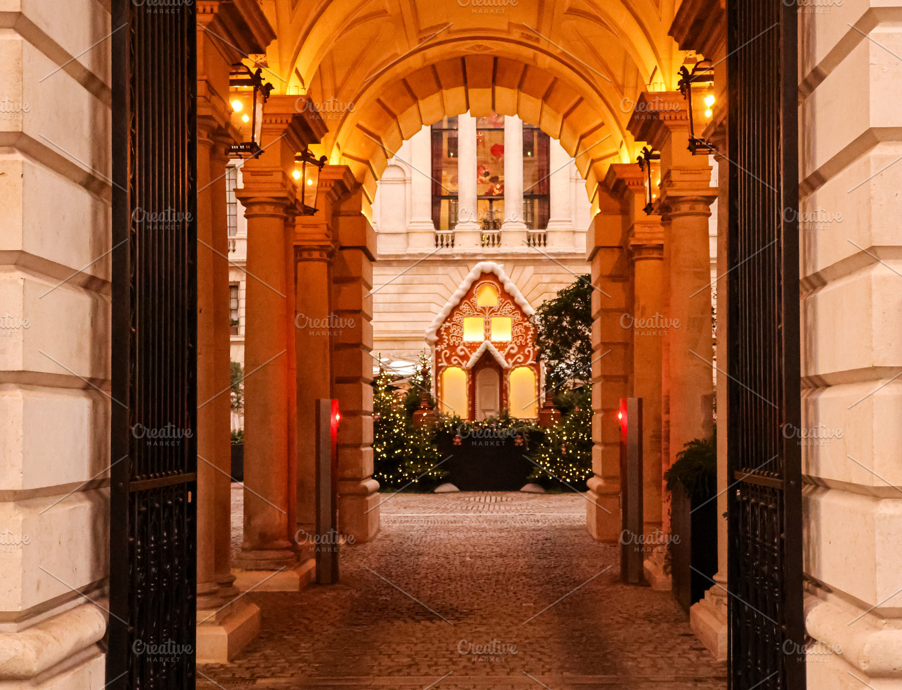 Gingerbread house with festive lights and Christmas trees creating a holiday di, a Photo by Studio ANNA